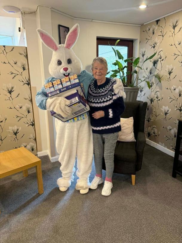 staff and resident taking a photo for easter