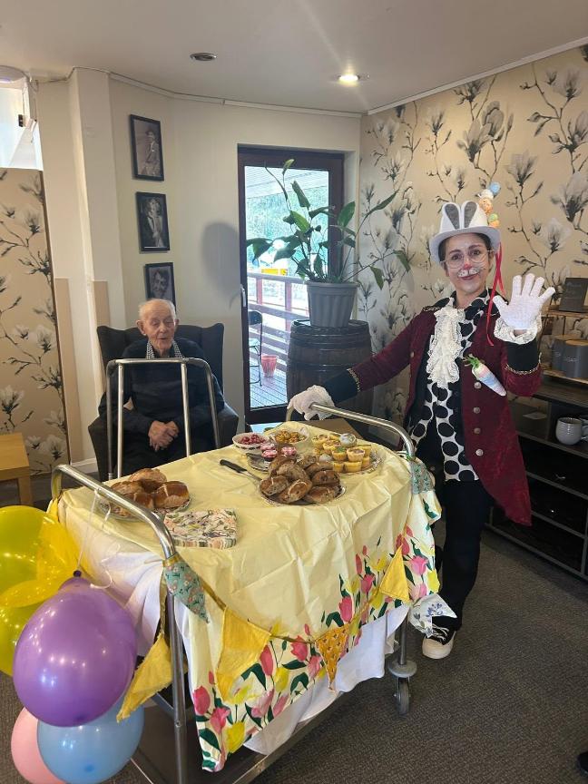 staff and resident taking a photo for easter