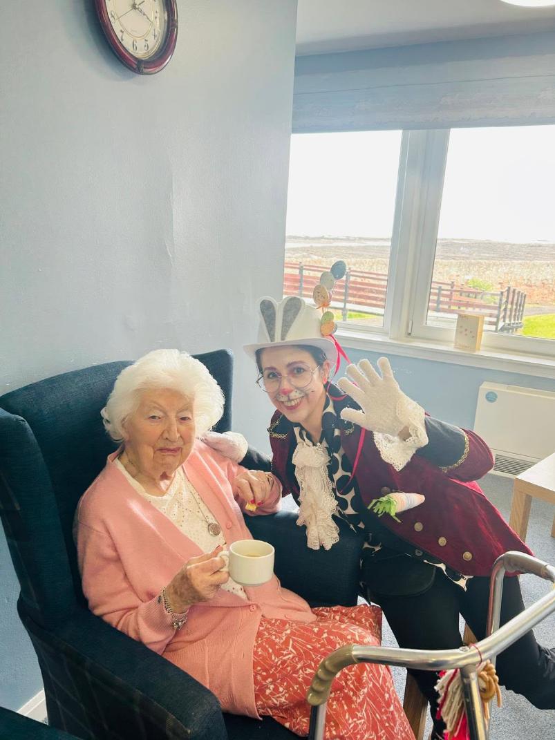 staff and resident taking a photo for easter
