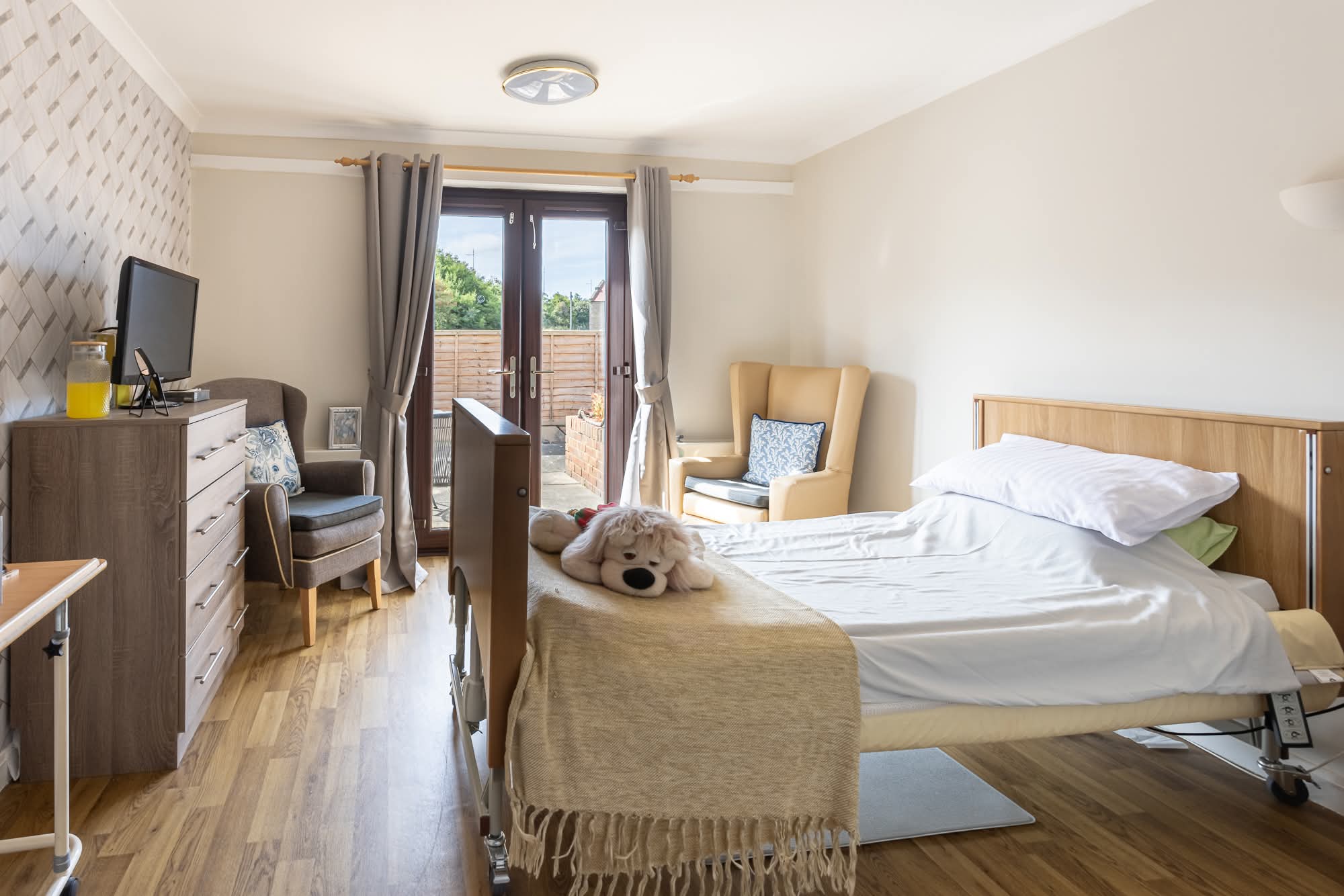 personalised bedroom with patio door at lammermuir house care home