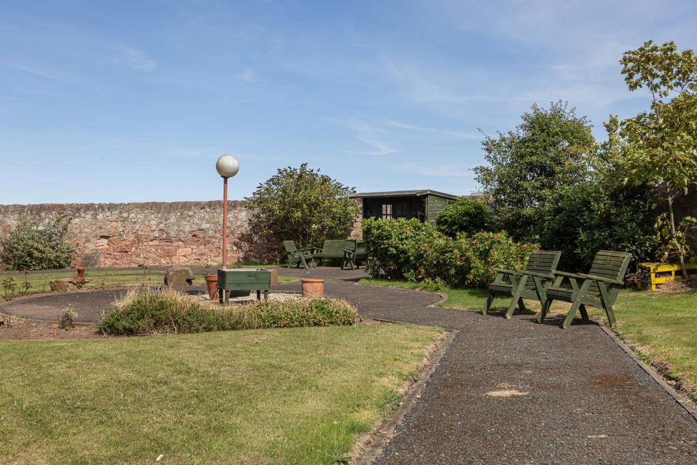 garden pathway and benches at lammermuir house care home