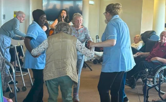 residents dancing together in communal area